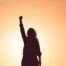 power pose from woman at sunset