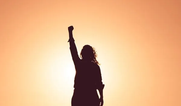 power pose from woman at sunset
